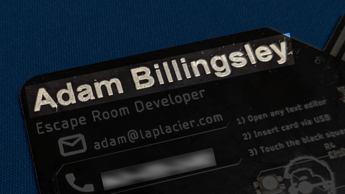 Closeup of business card v1 where text is masked, revealing a metallic sheen Business Card v1 Masking